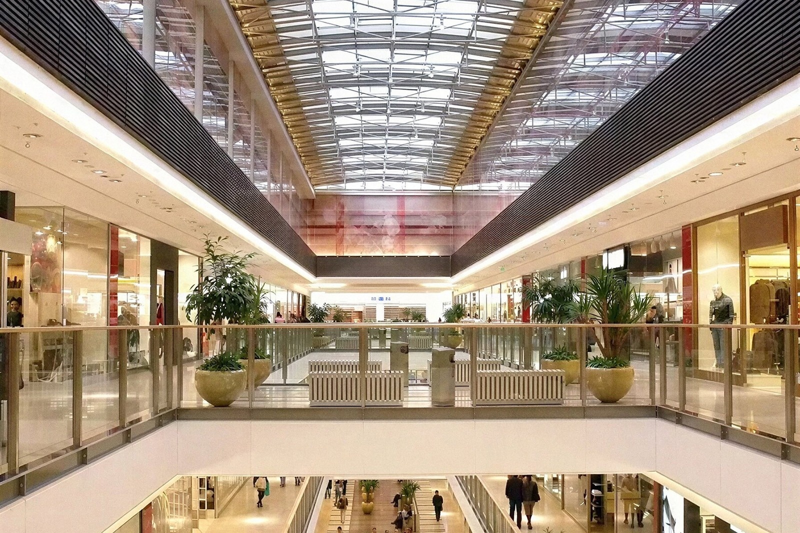 Interior moderno de centro comercial Tequendama: Corporativa, con luz natural y plantas.