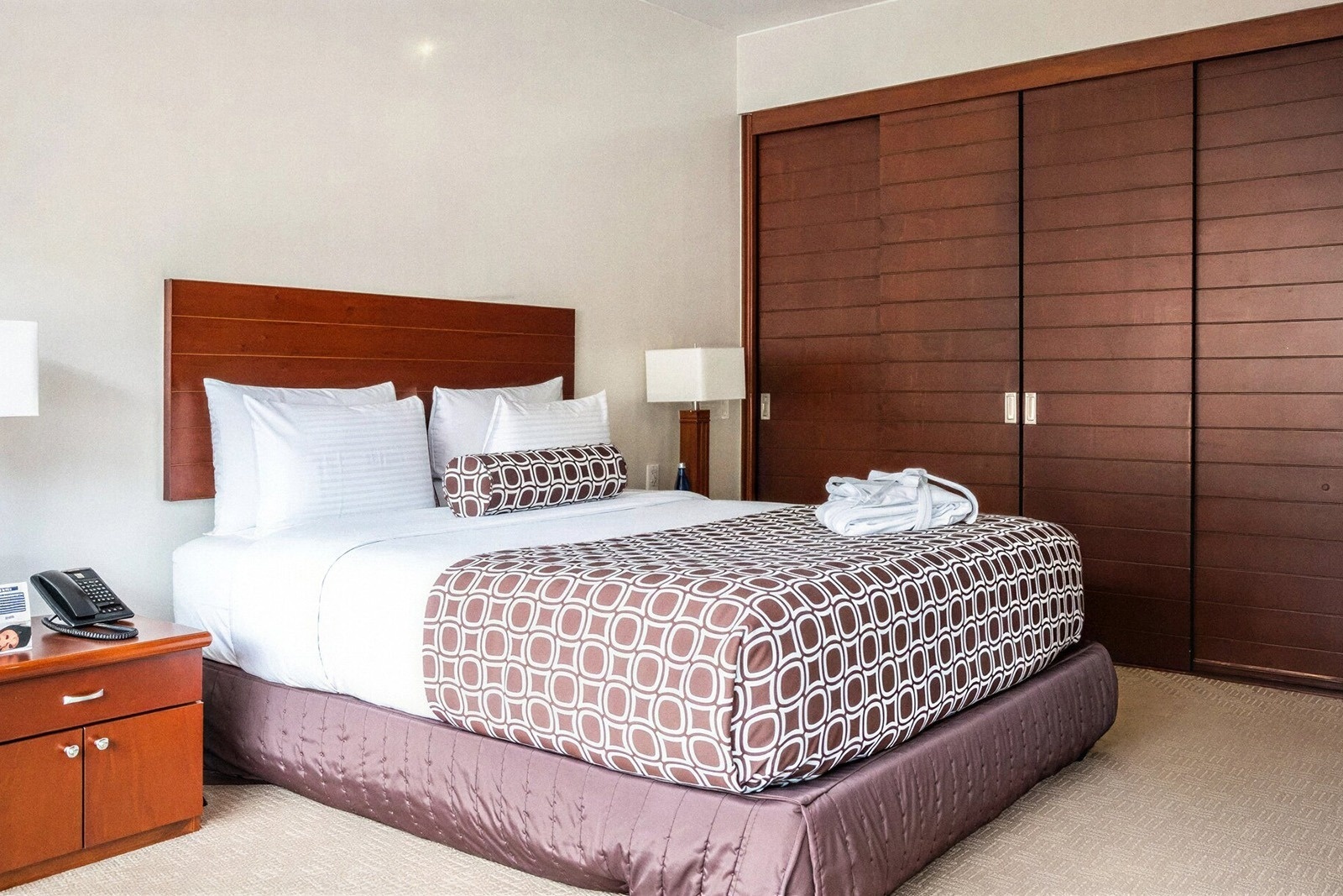 Tequendama Suites Bogotá: Plush bedding, modern wardrobe, and bedside table in a Bogotá suite.