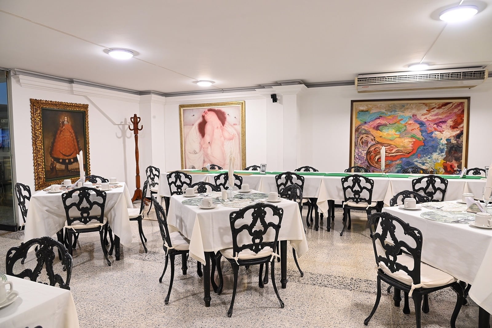 Tequendama event hall: tables set, art, and corporate style.