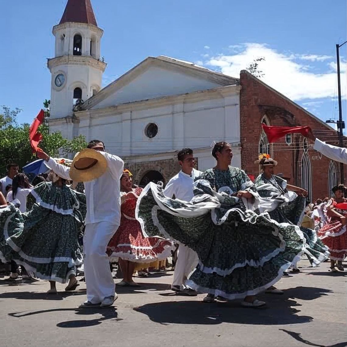 Tequendama: Danza tradicional y cultura vibrante frente a iglesia histórica.