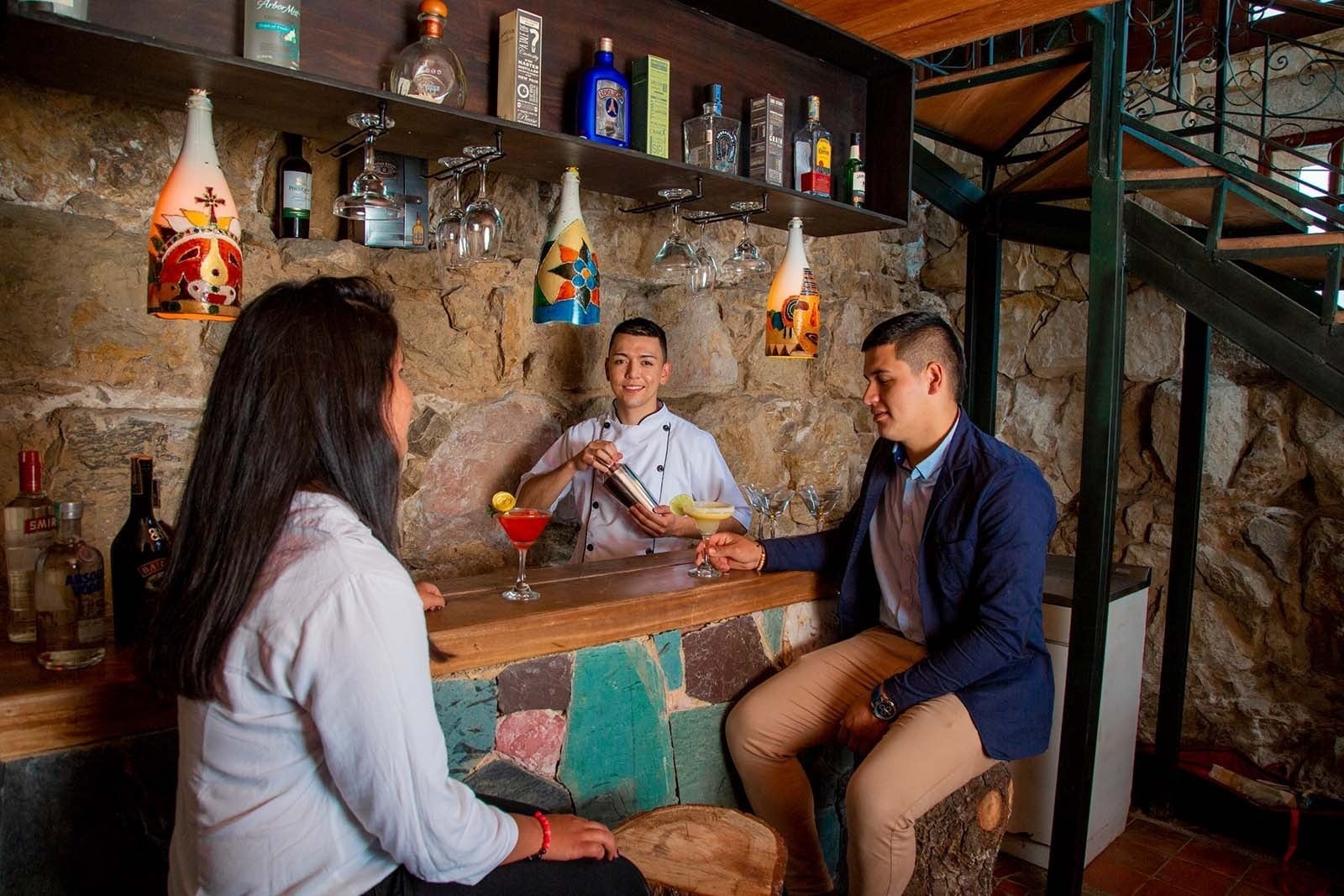 Modern bar at Tequendama: Corporativa. Two guests enjoy cocktails.