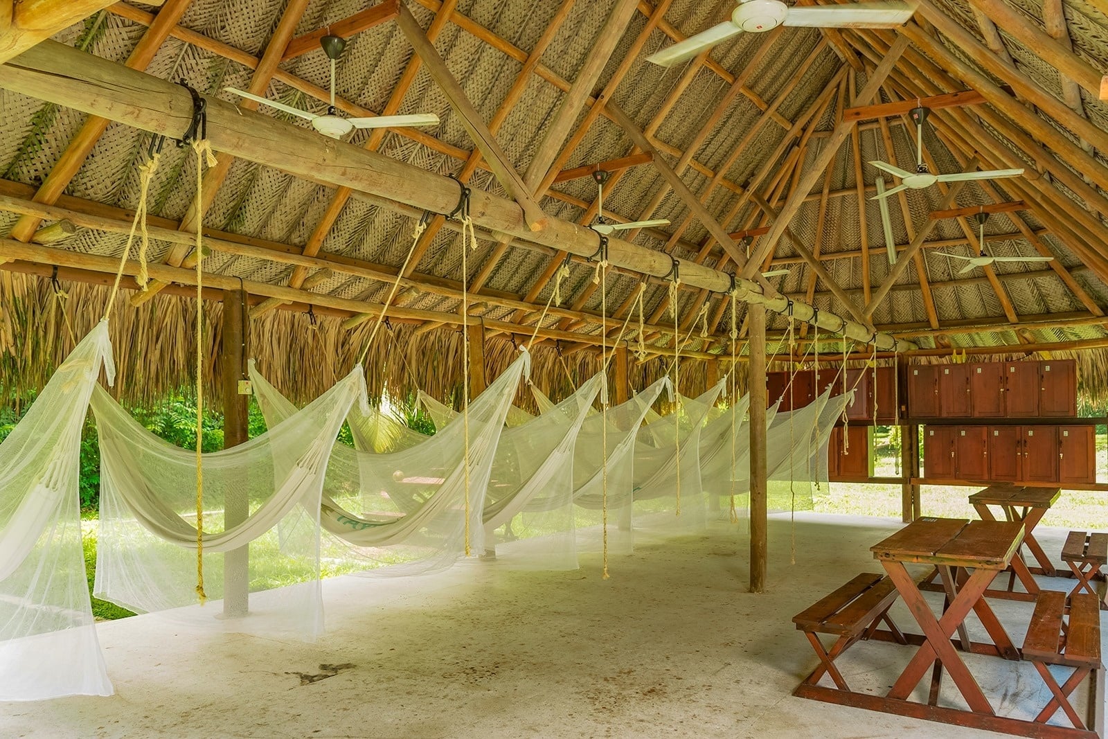 Ecohabs Tequendama: Hammocks with mosquito nets hang under a thatched roof at Tayrona Park Eco-Hotel.