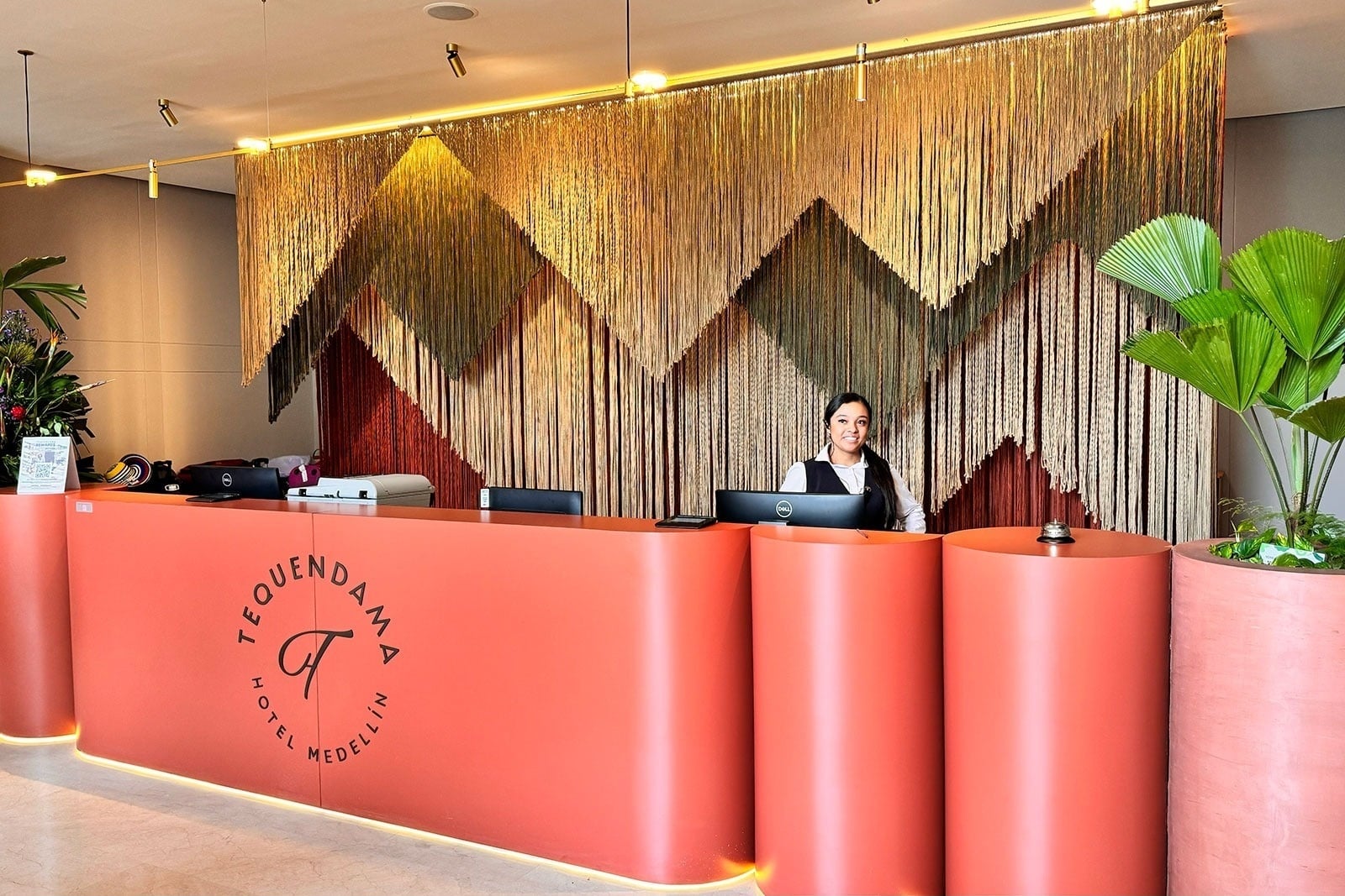 Tequendama Hotel Medellín: Chic reception with a welcoming attendant and modern decor.