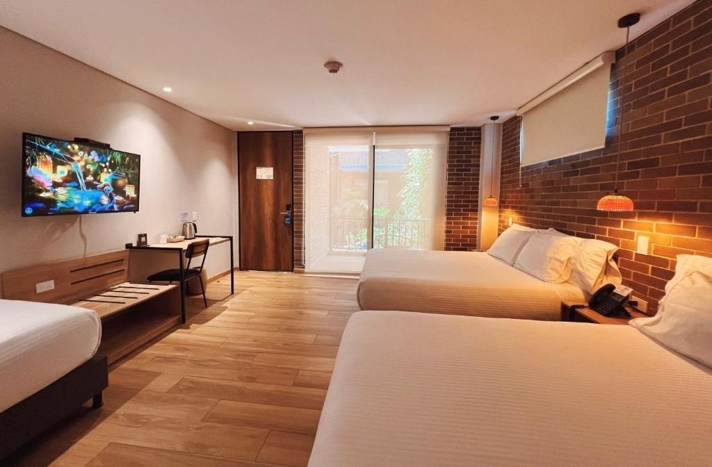 Spacious hotel room at Casa Rosé Hotel | Boutique Hotel in El Carmen de Viboral with two queen beds.