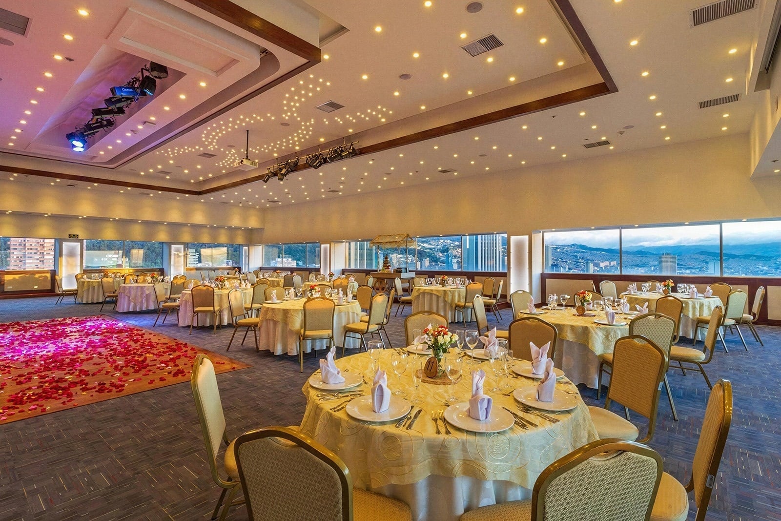 Elegant ballroom for events at Tequendama Suites Bogotá, featuring round tables and city views.
