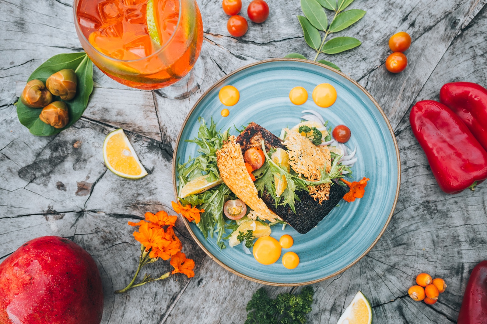 A gourmet fish dish at Tequendama: Corporativa, served with fresh ingredients and a refreshing drink.