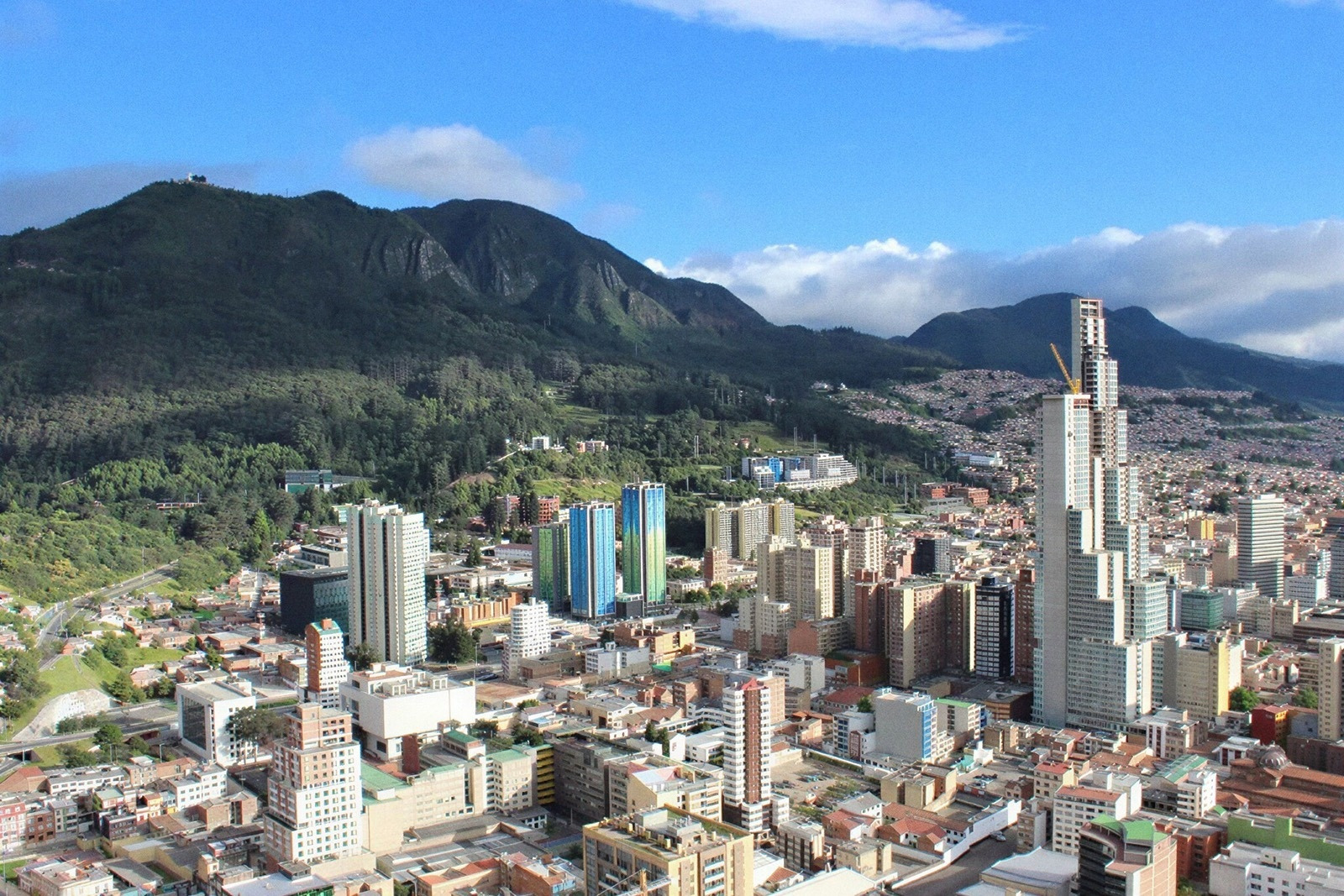 Hotels in Bogota: Skyline view of Bogota with mountains and skyscrapers. Book Tequendama Hotels.