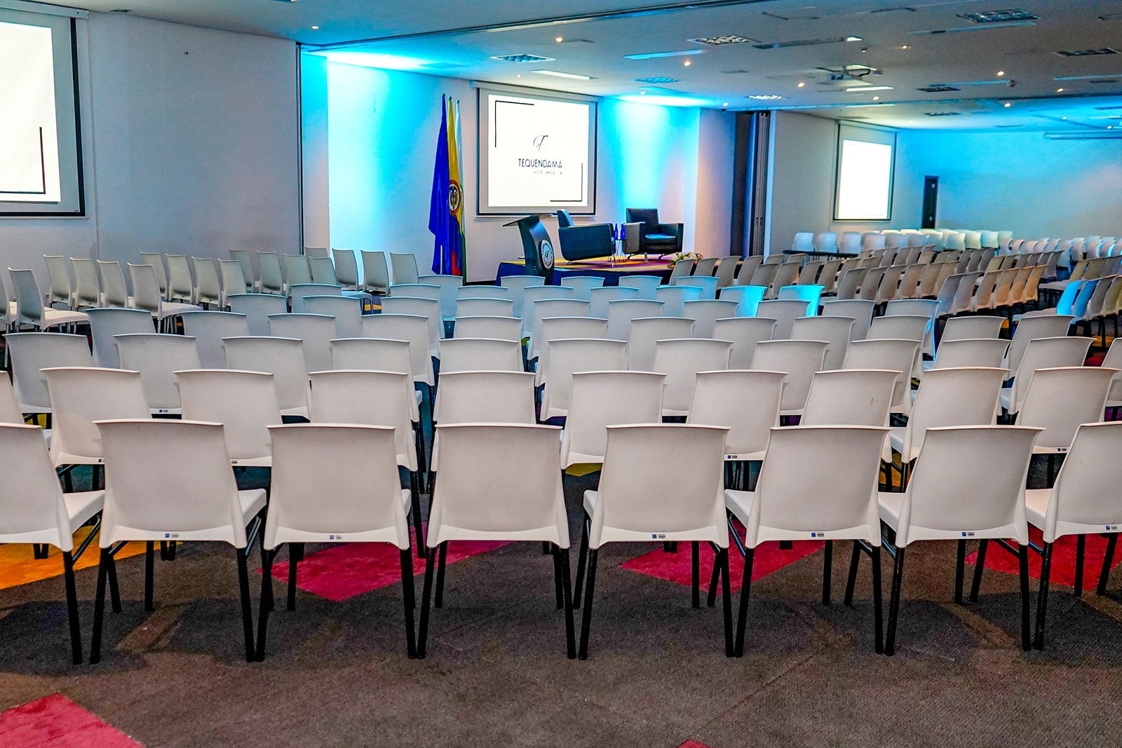 Tequendama Hotel Medellín | Modern conference room with white chairs, ideal for events.