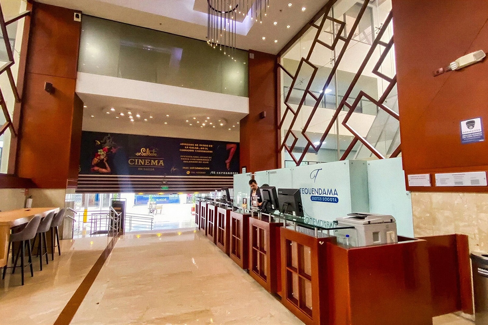 Tequendama Suites Bogotá: Modern lobby with reception and cinema entrance. Experience comfort and style in Bogotá.
