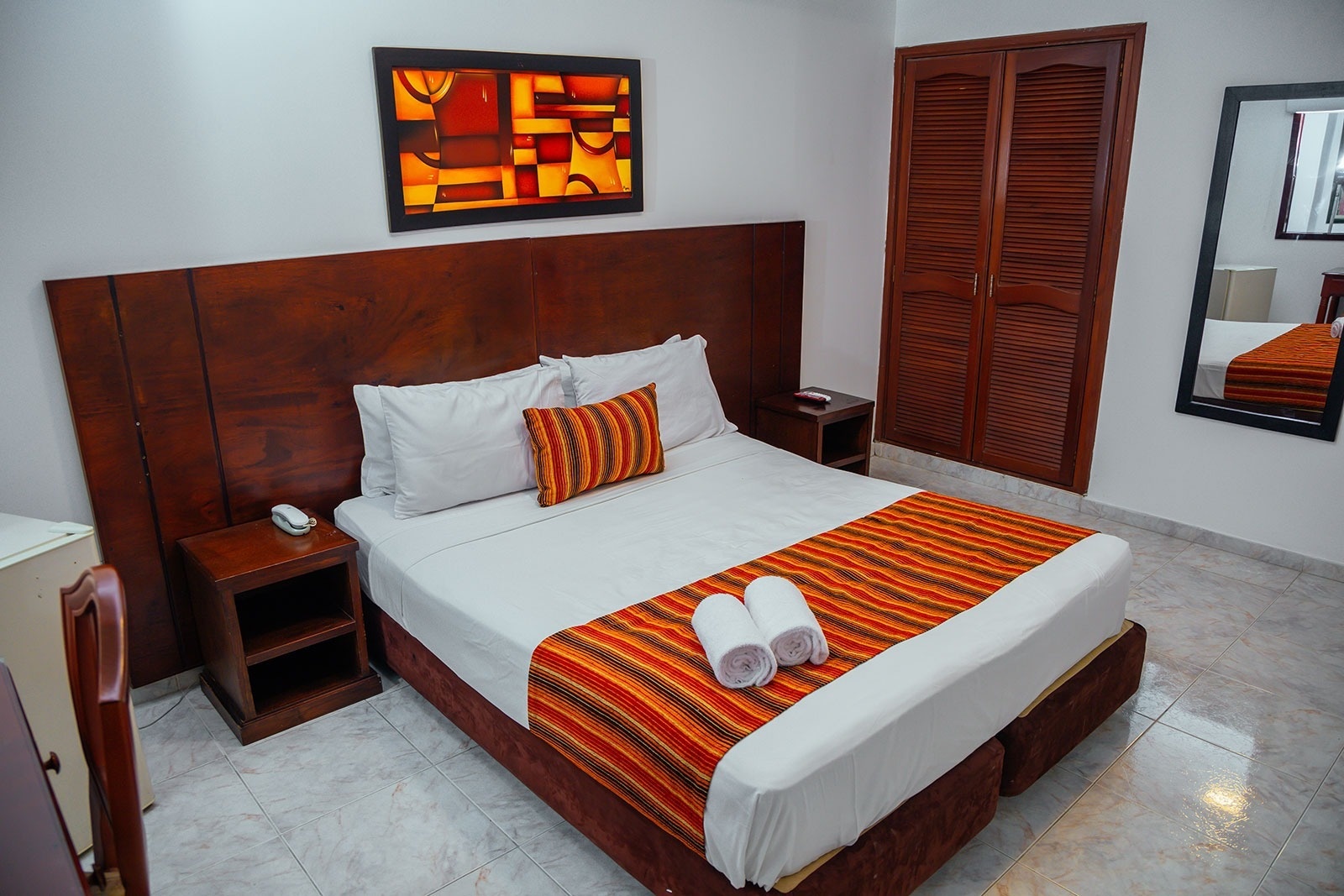 Comfortable queen bed at Tama Hotel Granada Real, North Cali. Book your stay now!