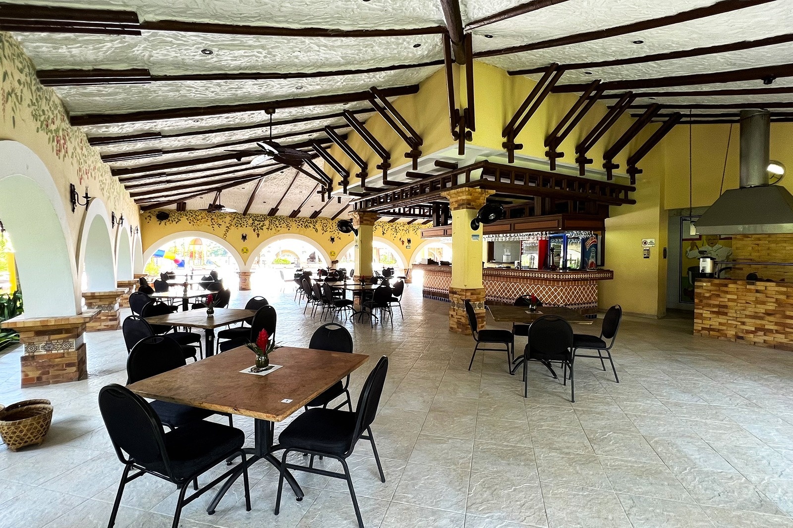 Tequendama: Outdoor dining area and bar with tables and chairs.