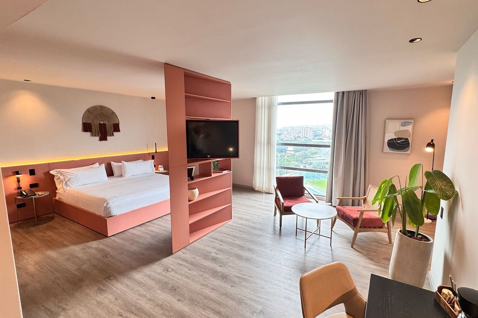 Tequendama Hotel Medellín: Modern room with king bed, seating area, and city view.