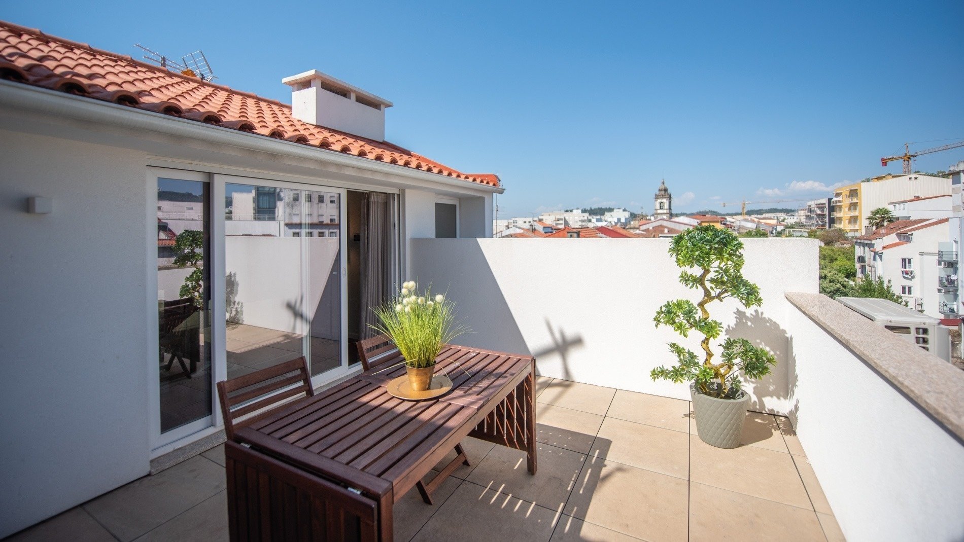 uma mesa e cadeiras em uma varanda com vista para a cidade