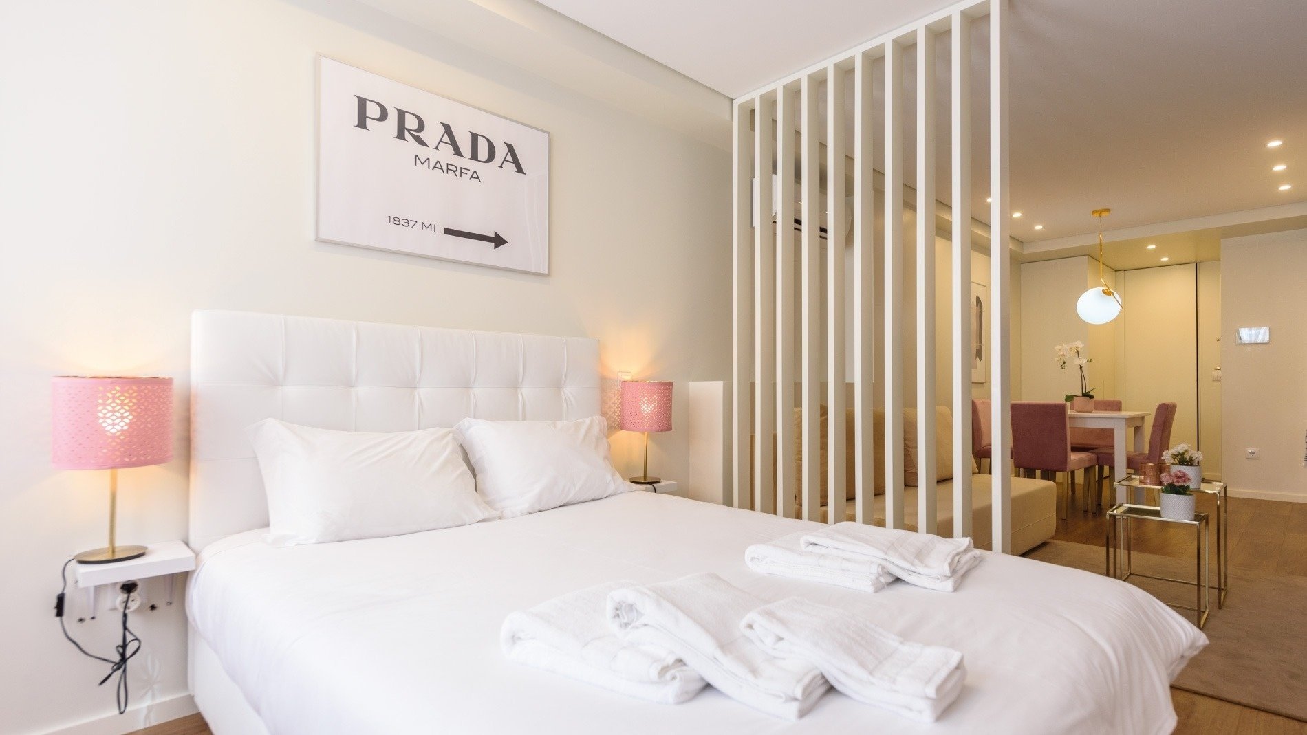 a bedroom with a prada sign above the bed