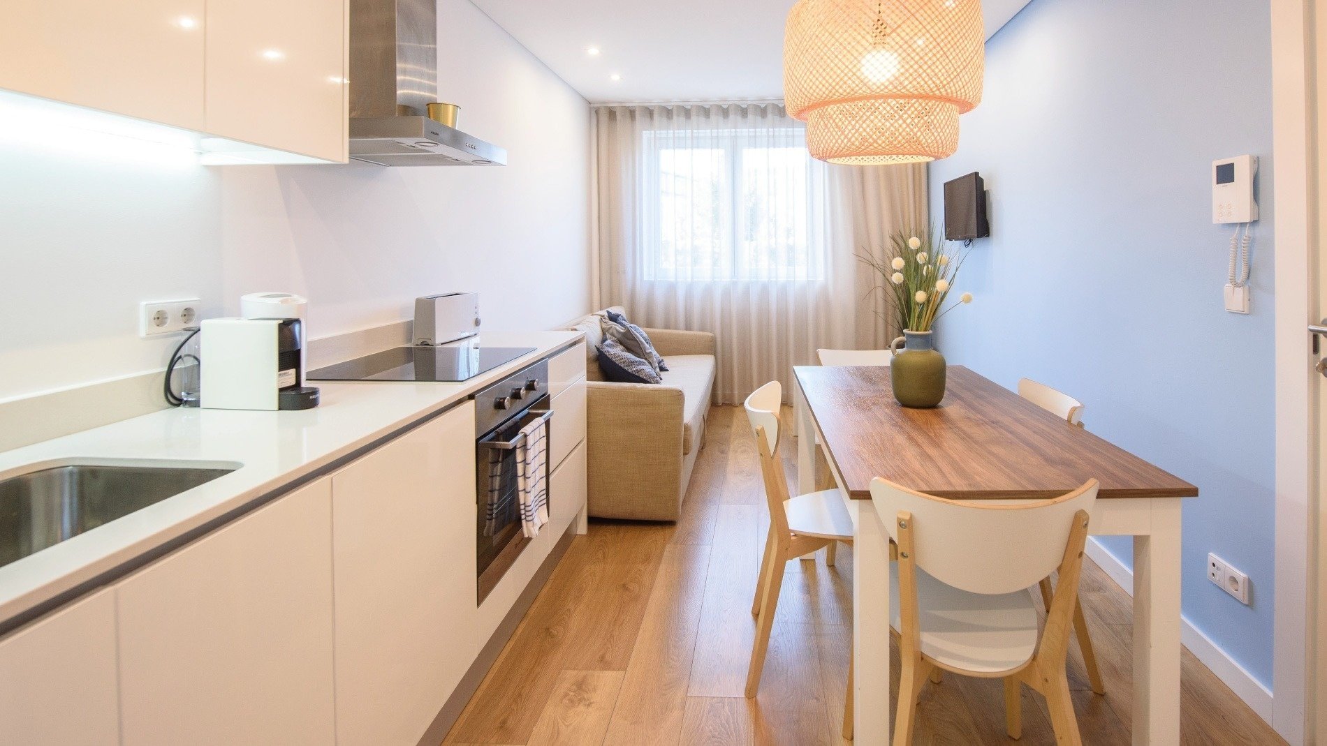 a kitchen with a table and chairs and a couch