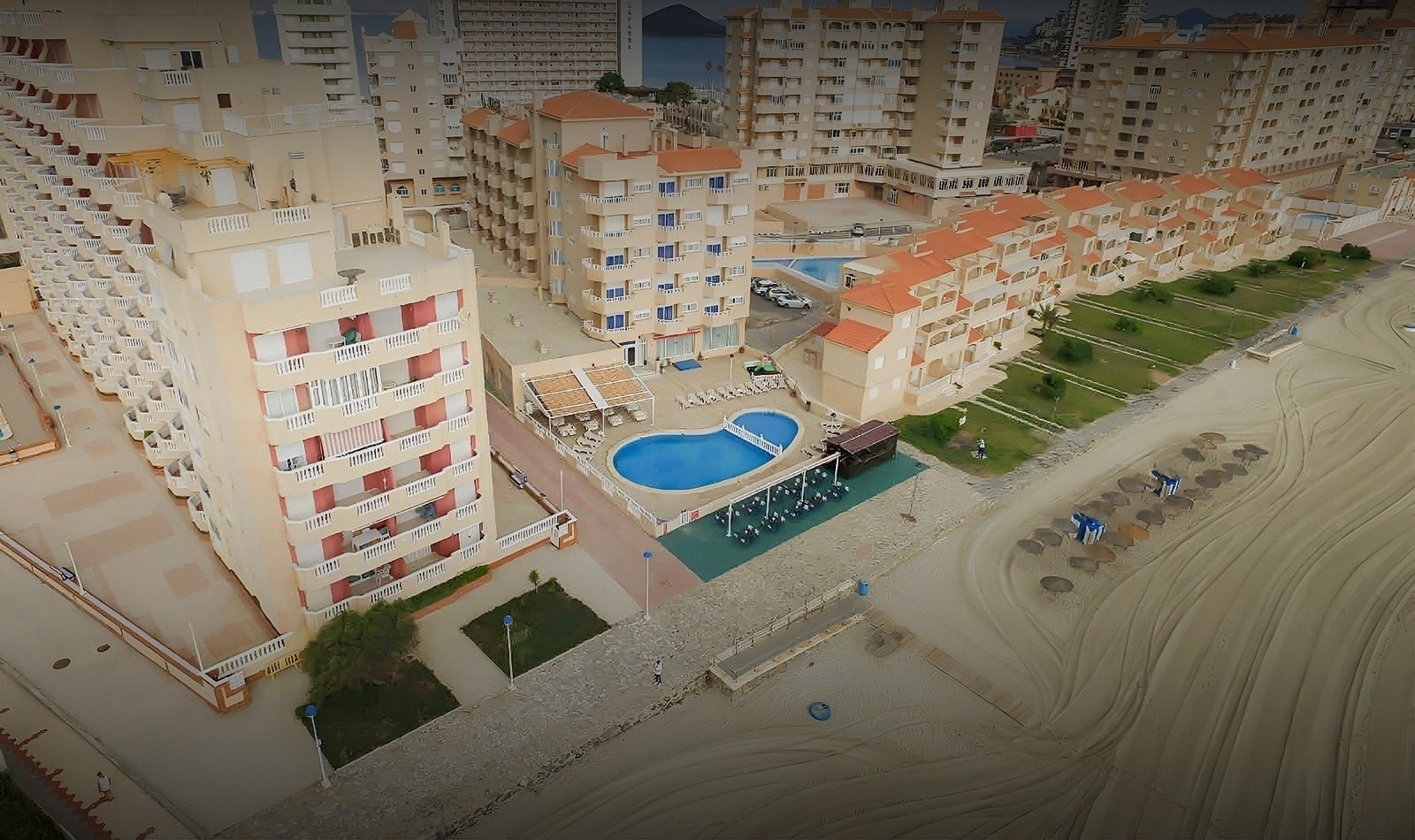 una vista aérea de un complejo de apartamentos con una piscina