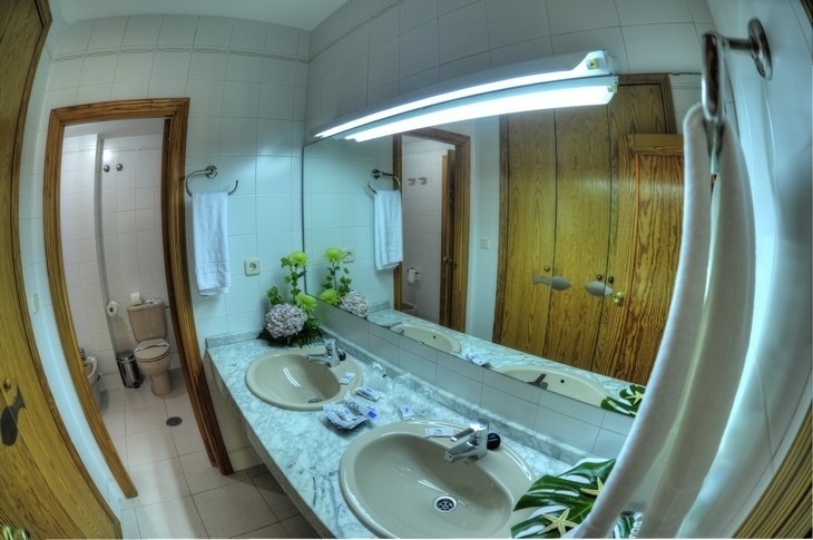 a bathroom with two sinks and a large mirror