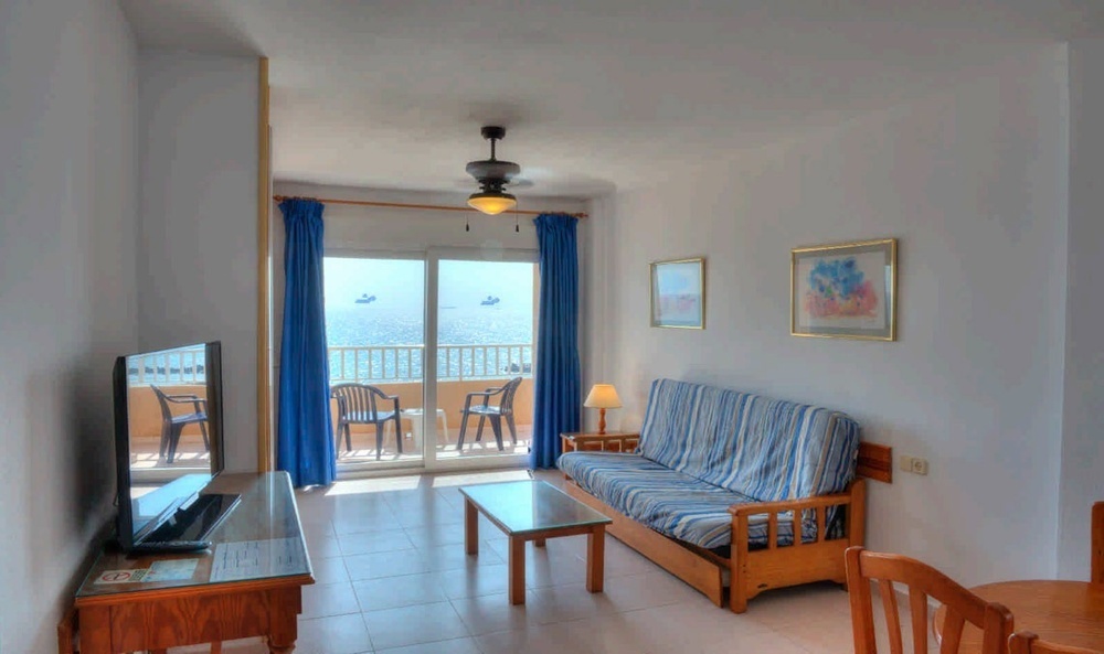 a hotel room with a bed and sea views