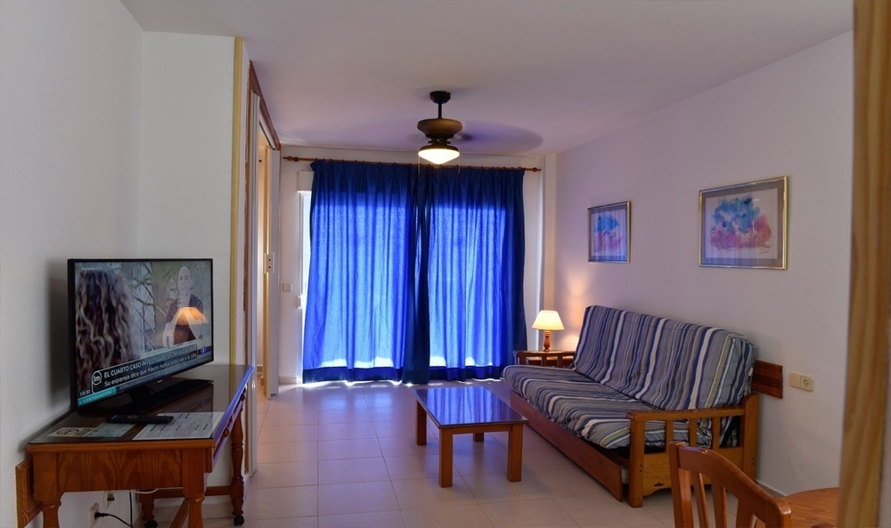 a living room with a flat screen tv and a couch