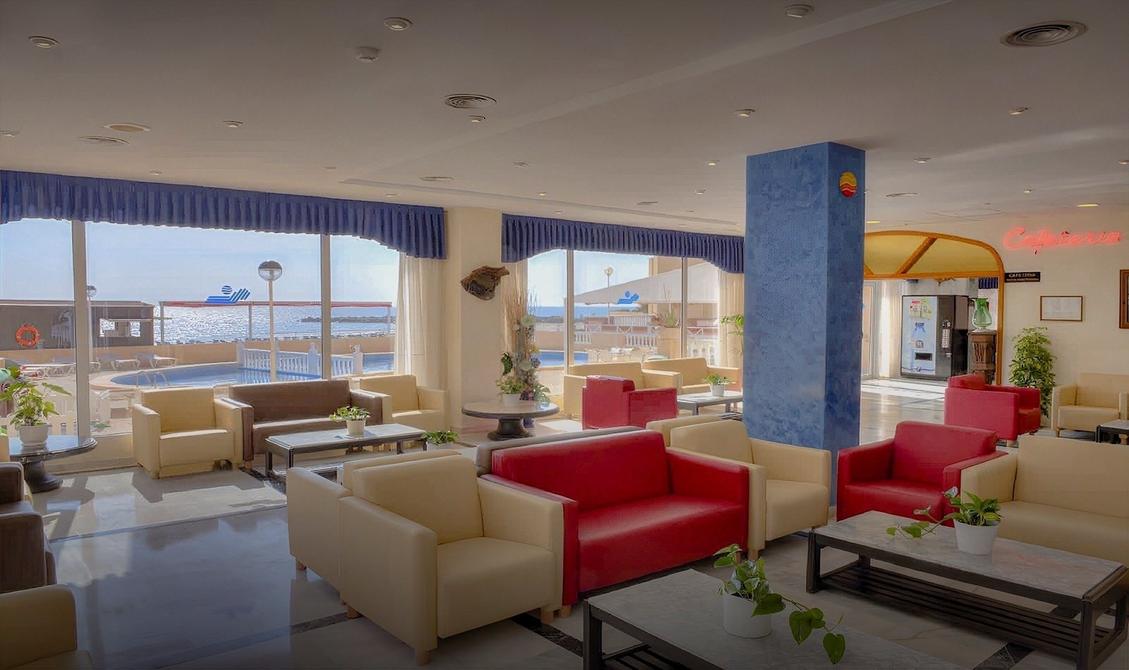 a hotel lobby with a red sign that says cafeteria