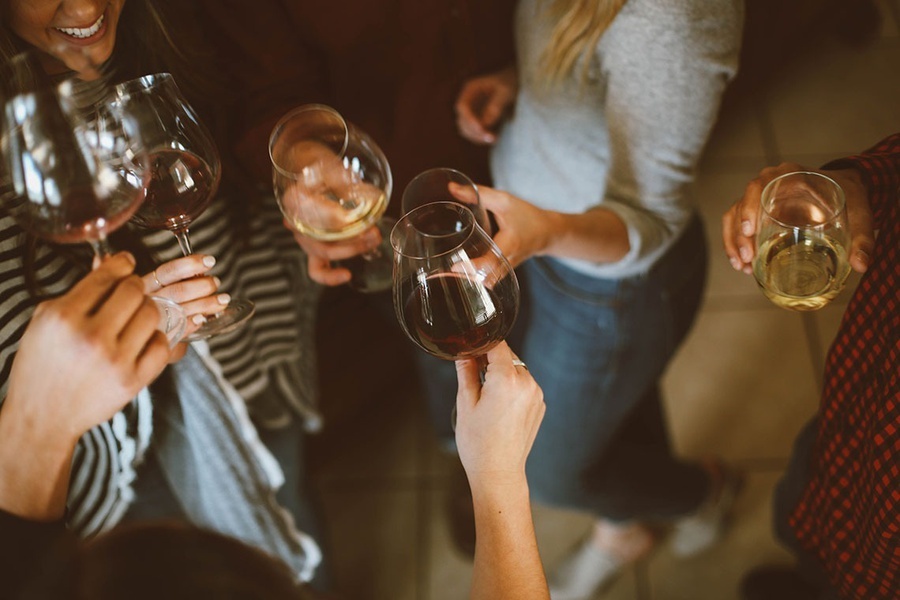 a group of people are toasting with wine glasses