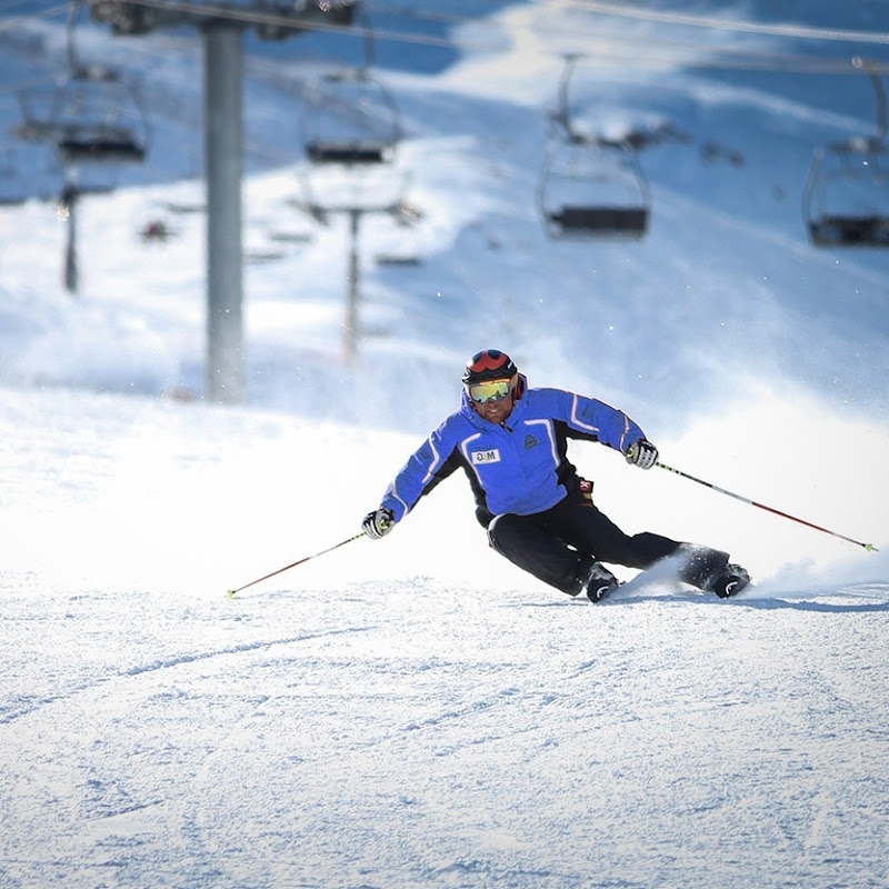 un esquiador con una chaqueta azul y negra con la palabra sns en el pecho