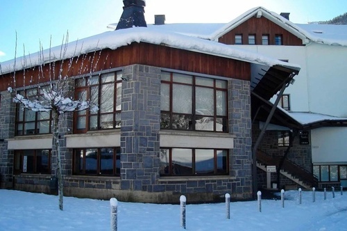a building with snow on the roof and a sign that says ' a ' on it