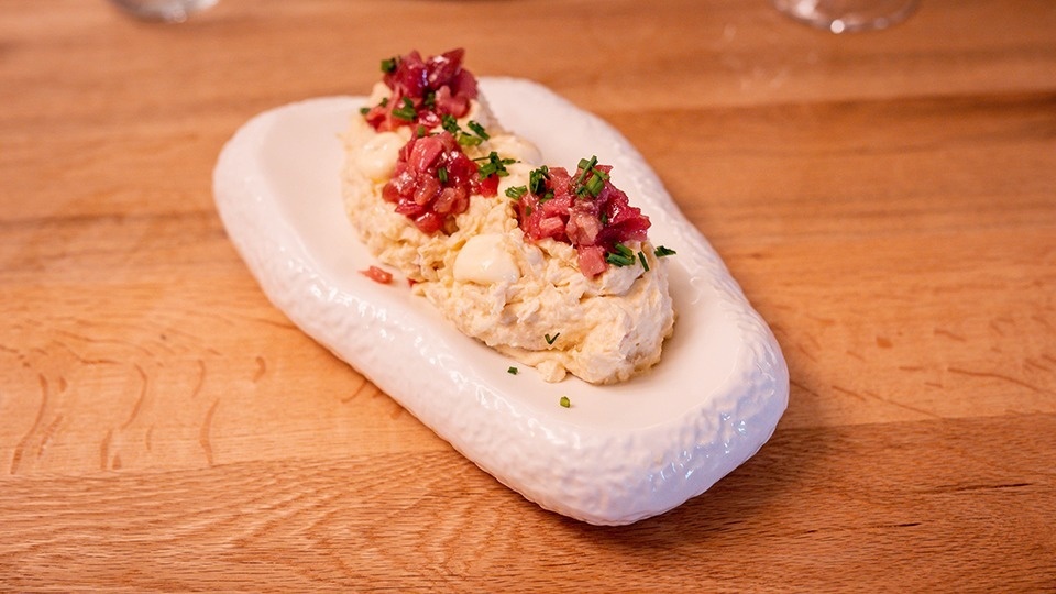 a white plate with food on it on a wooden table