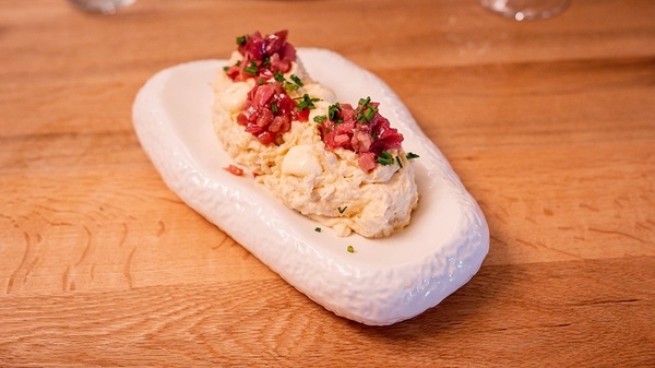 a white plate with food on it on a wooden table