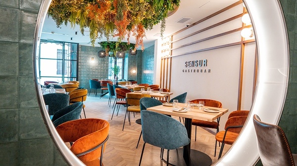 a restaurant called sensur gastrobar has tables and chairs