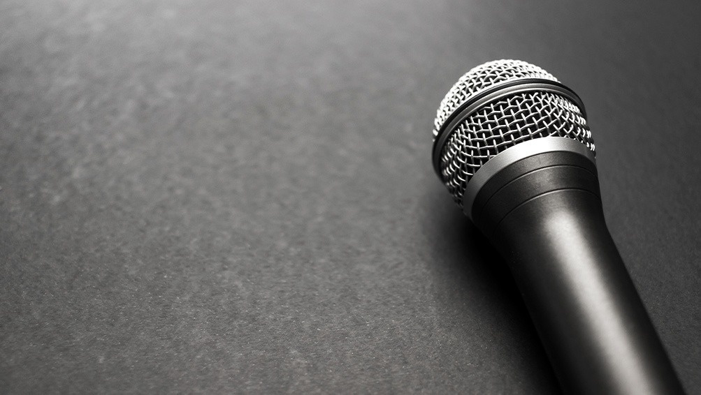 a black microphone is sitting on a black surface