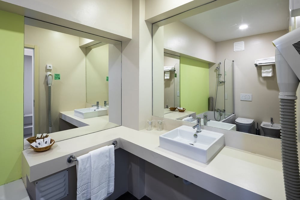 a bathroom with two sinks and a large mirror