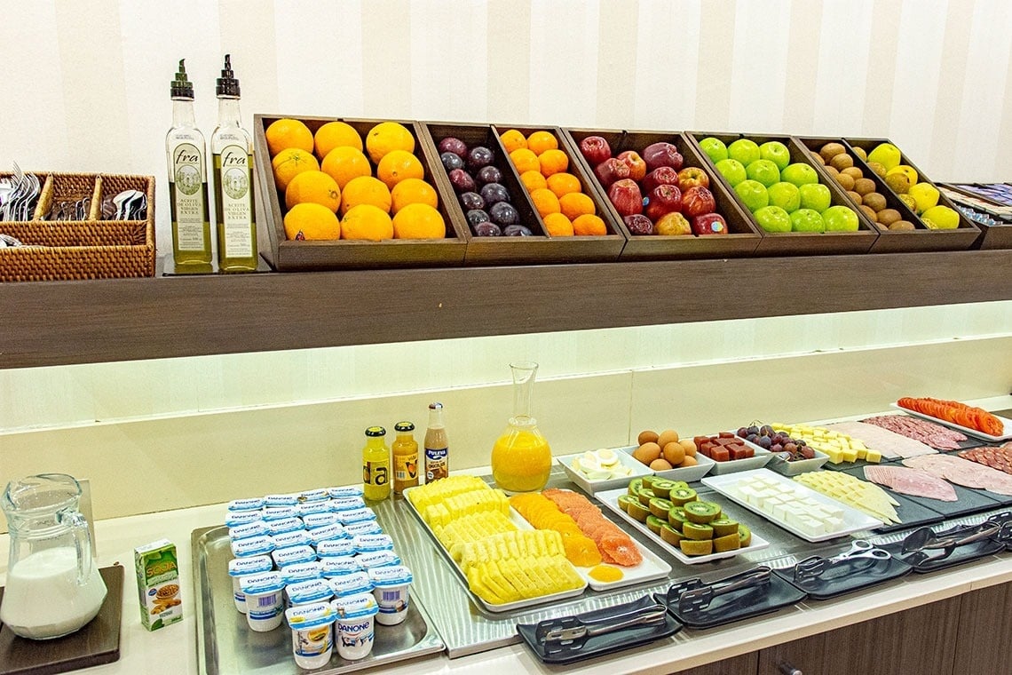 a table with a variety of food and drinks including orange juice