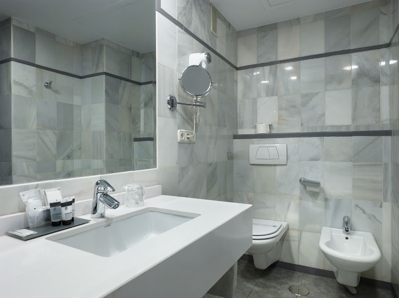 a bathroom with a sink toilet and mirror