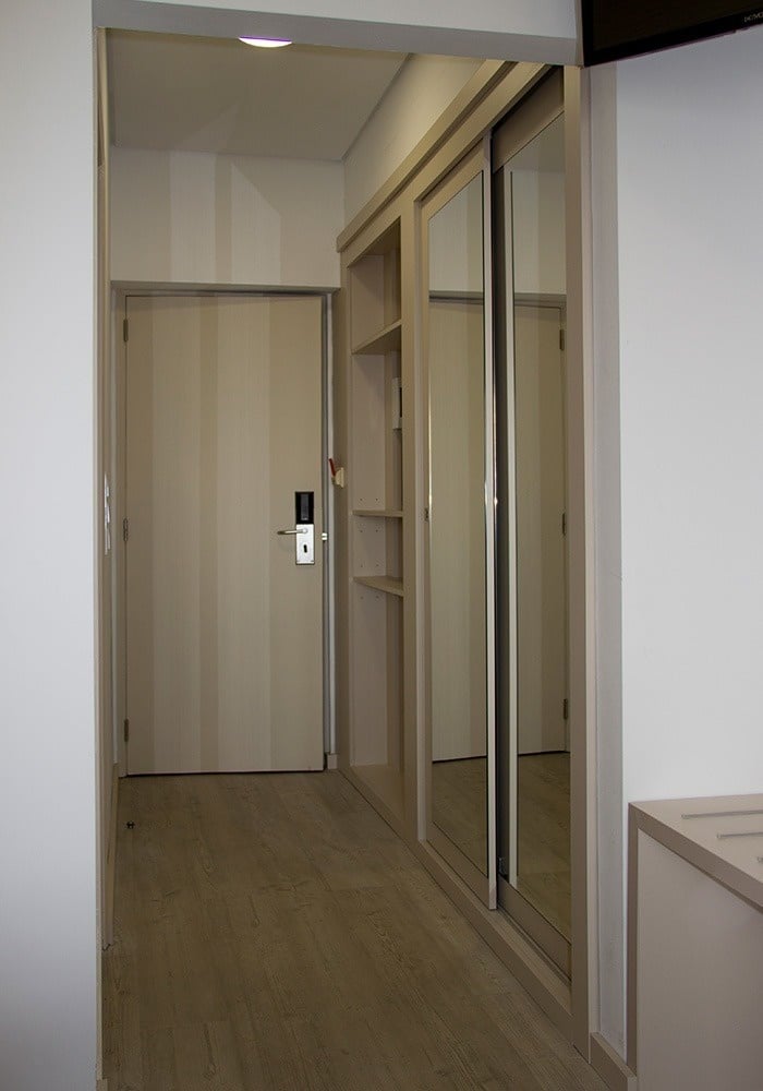 a hallway with a door that has a keypad on it