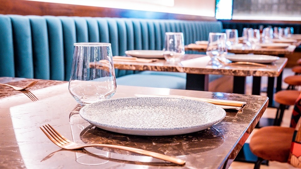 a plate and fork on a table in a restaurant