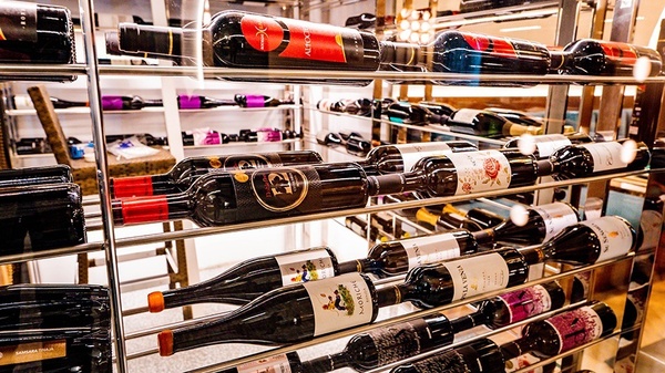 a row of wine bottles including a bottle of alba