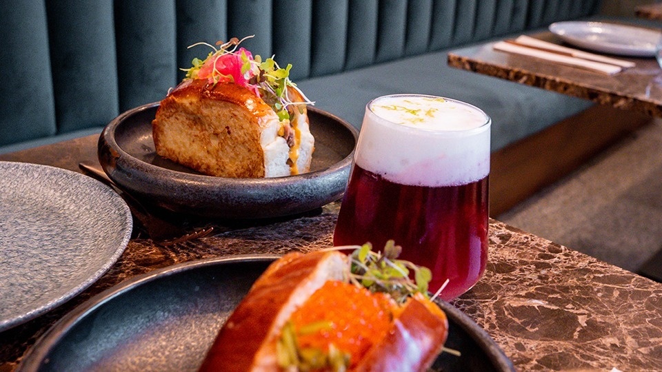 a plate of food and a glass of wine on a table