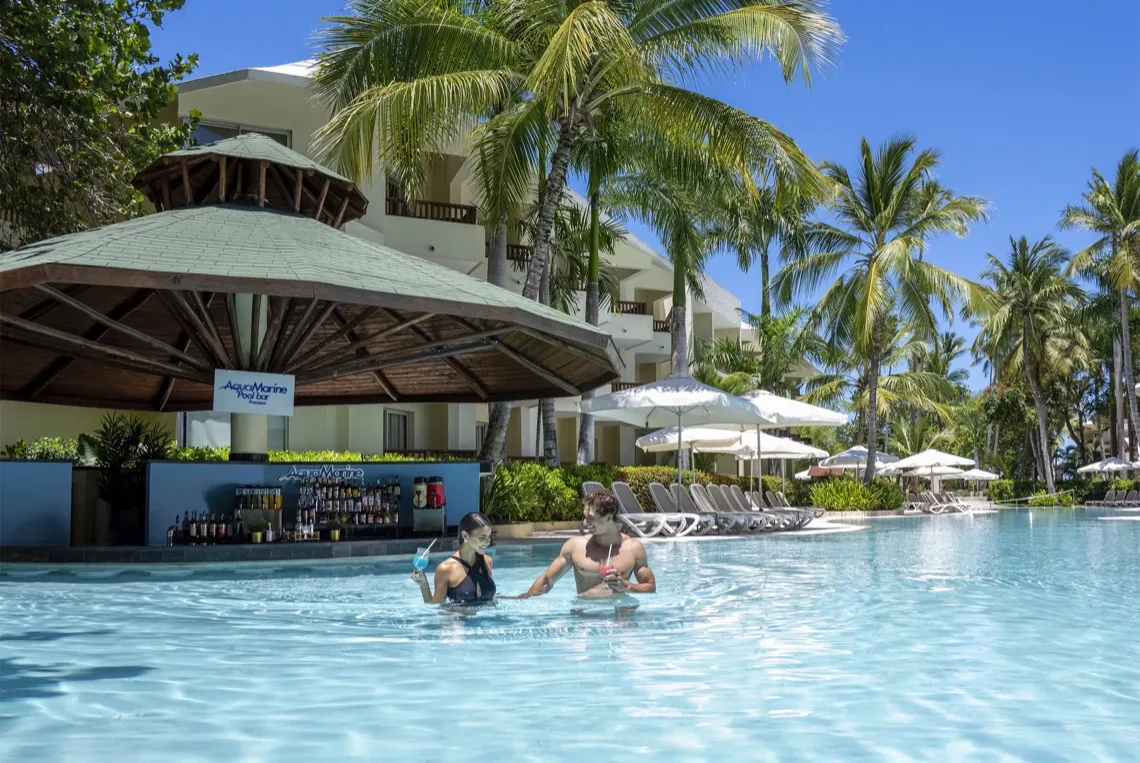 Paar genießt Cocktails im Pool an der Bar