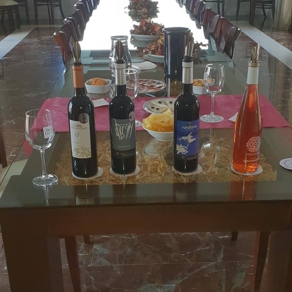 four bottles of wine are on a glass table including one that says 00