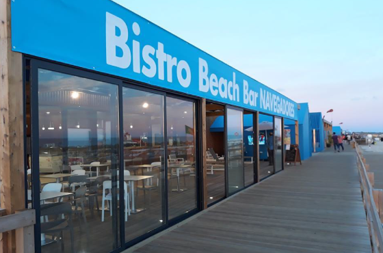 a blue and white sign for bistro beach bar