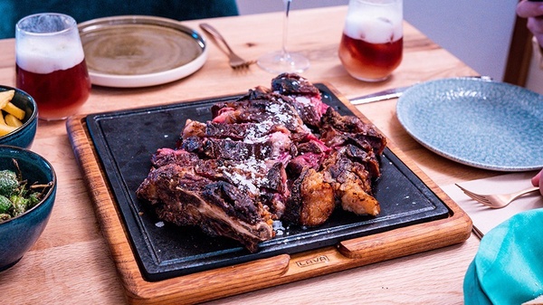 a large piece of meat is sitting on a wooden cutting board that says cava