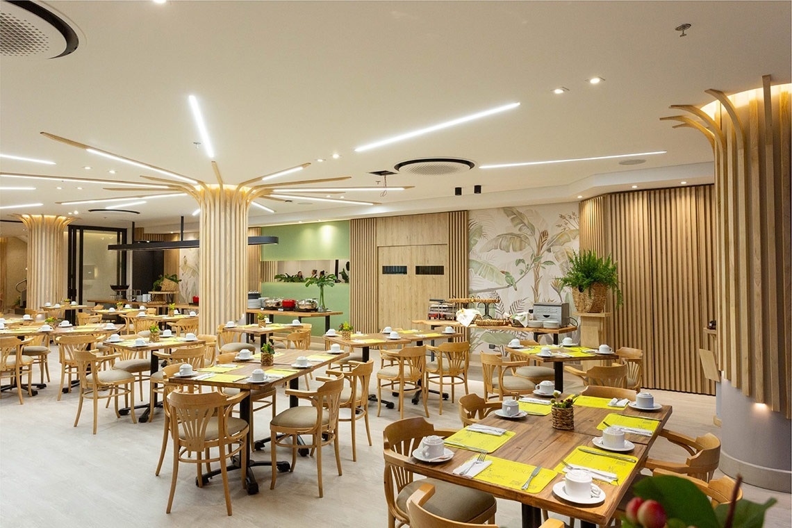 a dining room with tables and chairs set up for breakfast