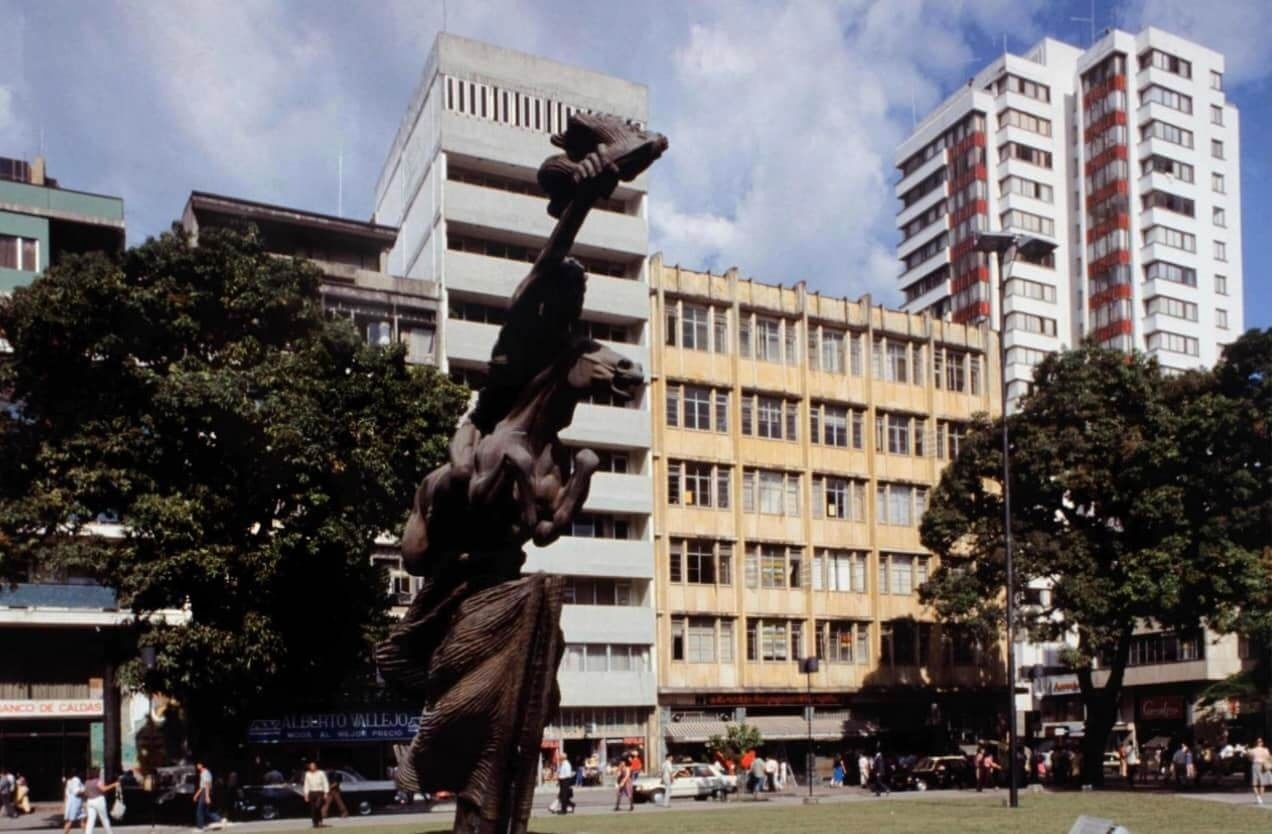 a statue in front of a building that says consulado