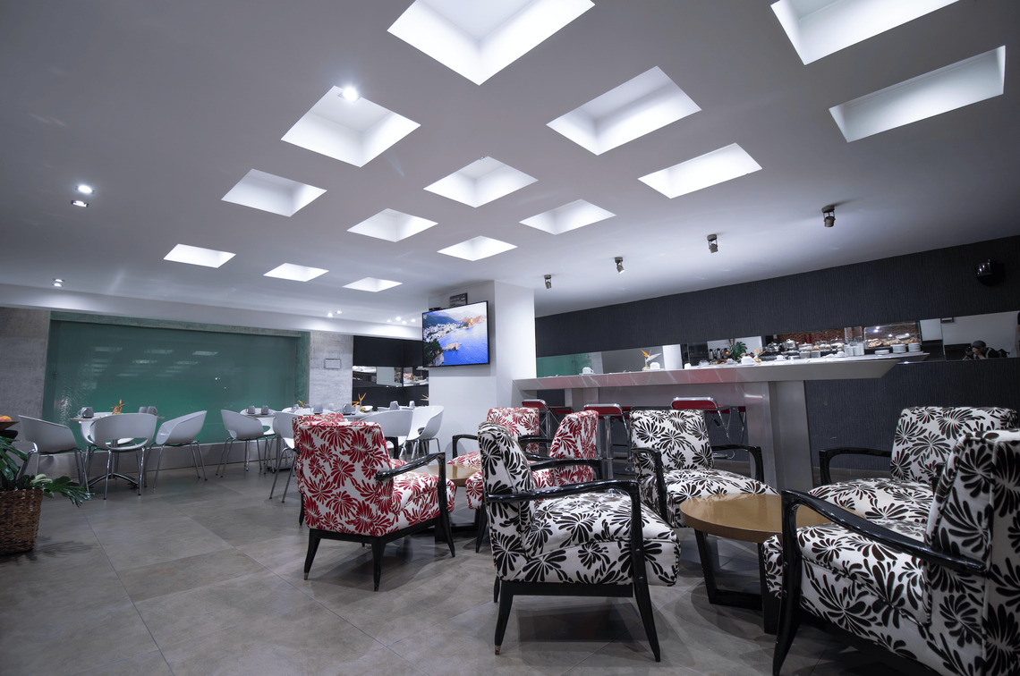 the word hotel is on the wall behind the tables