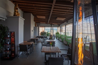 a restaurant with tables and chairs and a display of coca cola - 