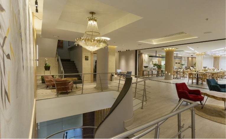 a large chandelier hangs from the ceiling of a restaurant