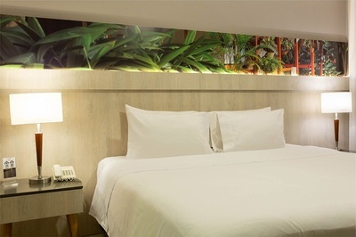 a hotel room with a bed and two lamps - 