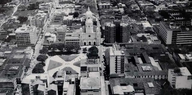 an aerial view of a city with a cathedral in the middle of it .