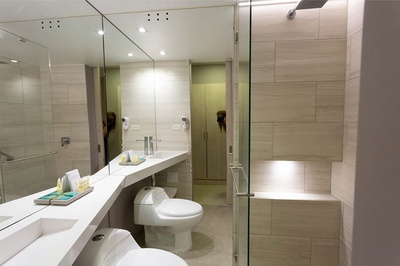 a bathroom with a toilet a sink and a shower - 